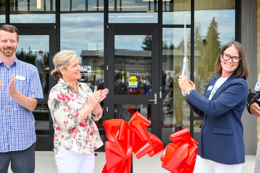 Board President Laurel Kingsbury cuts the ribbon.