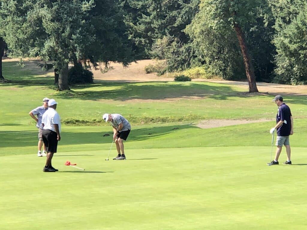 A foursome putting on a Madrona Links green Stunday.