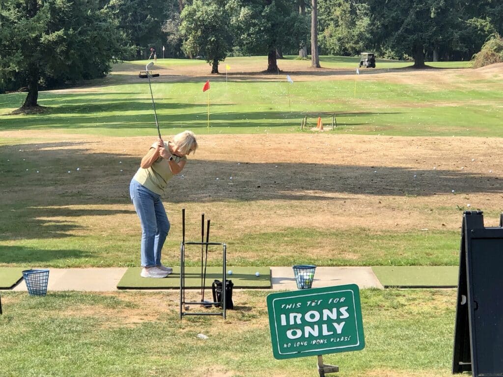 A woman practices her iron shots Sunday at Madrona Links.
