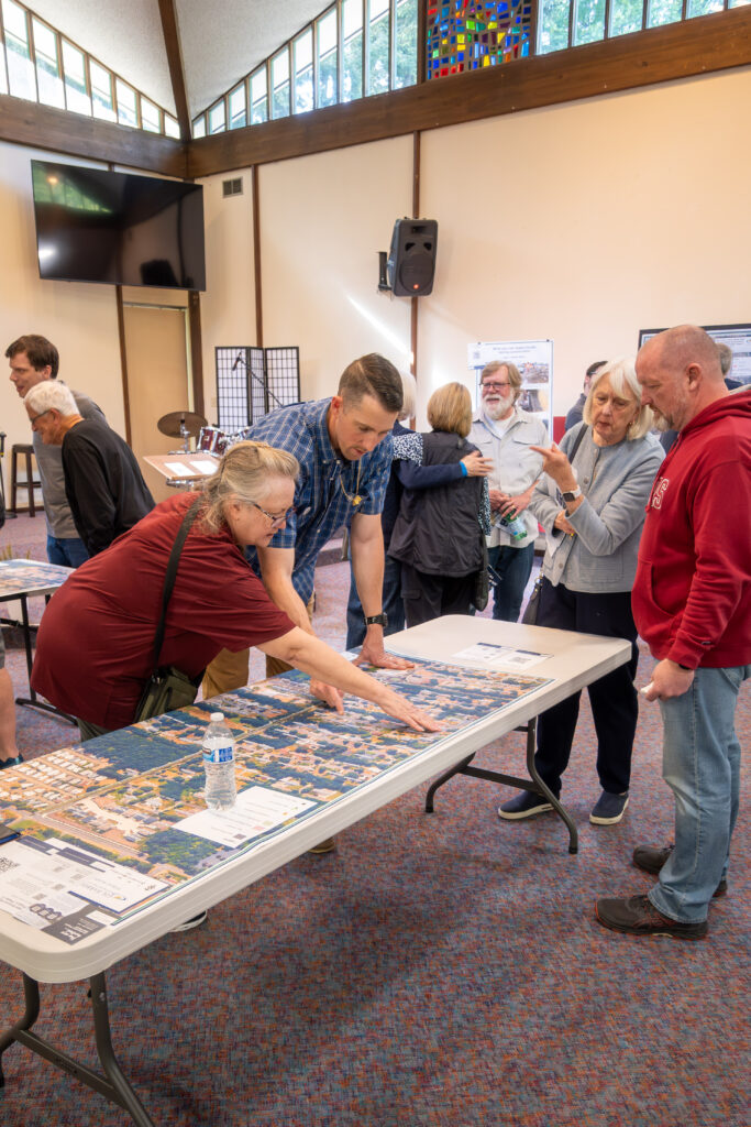 City of Gig Harbor Construction Supervisor Dan Munn shows a resident on a map the location of the project.