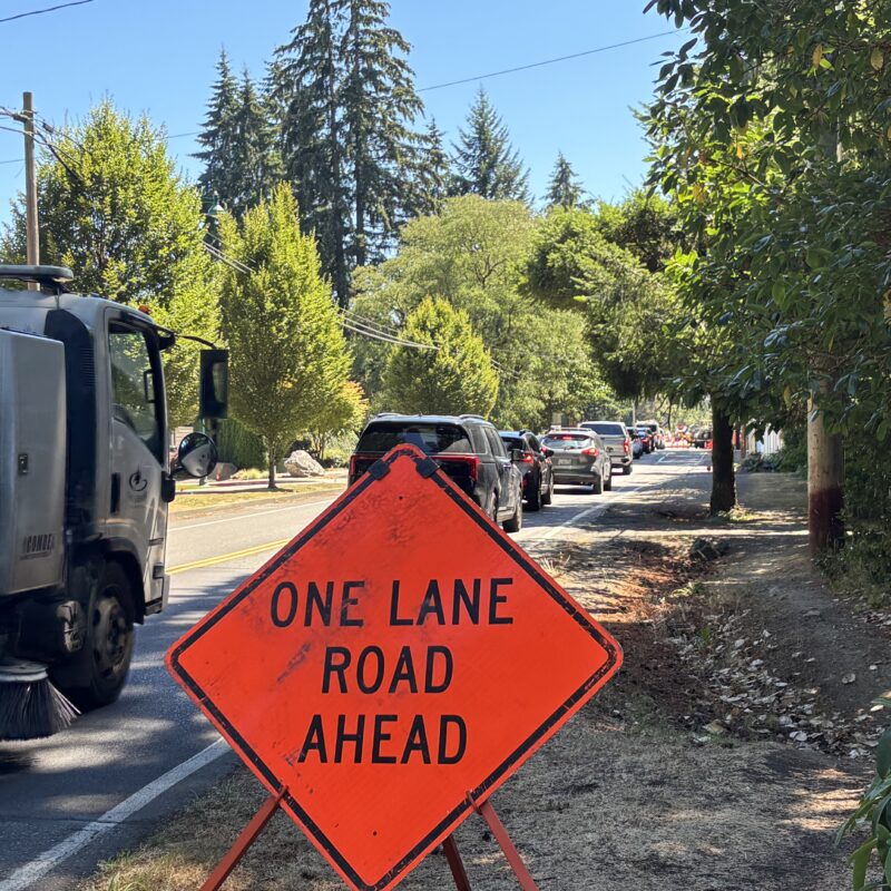 Cars are being directed to one lane at the intersection of 38th Avenue and 56th Street NW in Gig Harbor as workers begin road improvements that include a roundabout at the intersection.