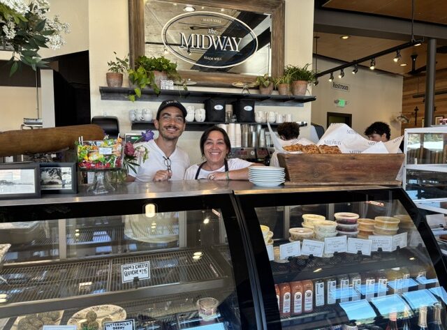 The Midway owners NIck Hosea and Trish Huff stand over their pastry counter. The Midway deli and sandwich shop opened July 2.