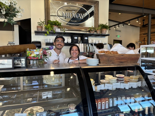 The Midway owners NIck Hosea and Trish Huff stand over their pastry counter. The Midway deli and sandwich shop opened July 2.